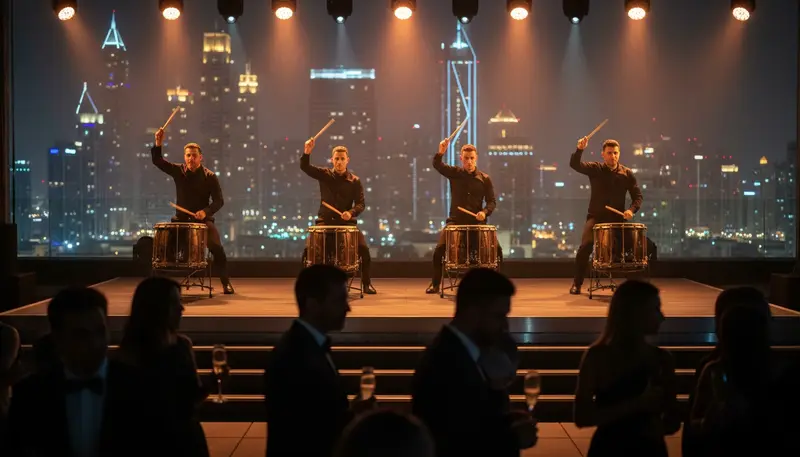Group of drummers playing large drums on a stage at a night event with the Dubai skyline behind